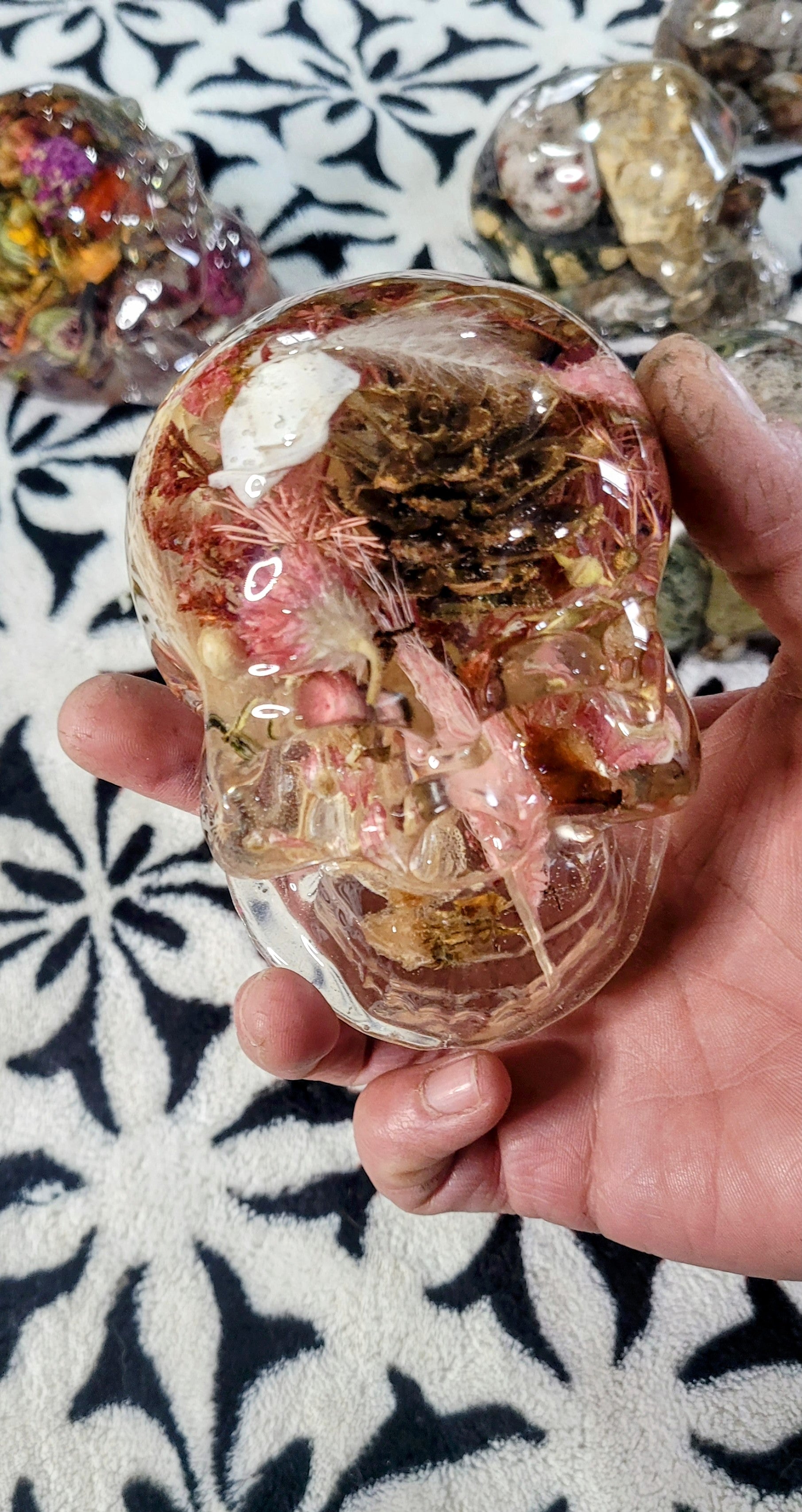 Side view of pink resin skull showing detailed lacing and clear resin finish